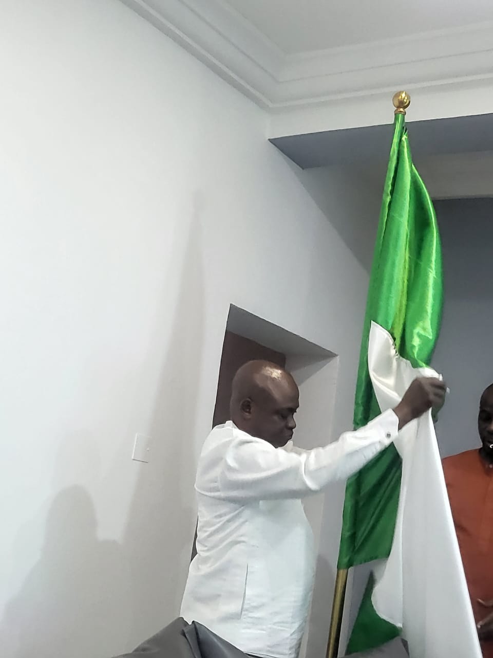 Apostle Ayodele David-Adesua honoring the Nigerian flag